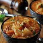 bowl of cabbage roll soup with a pepper grinder