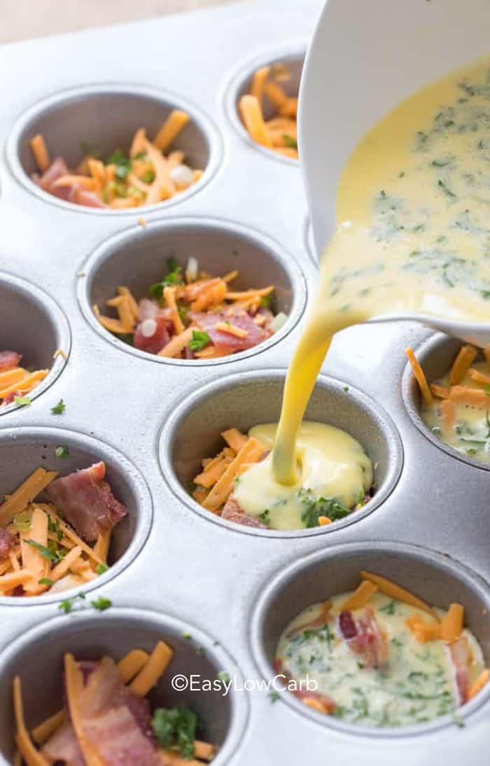 pouring eggs in tins for Bacon Egg Muffins