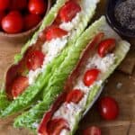 Two BLT Egg Salad Wraps on a wooden board