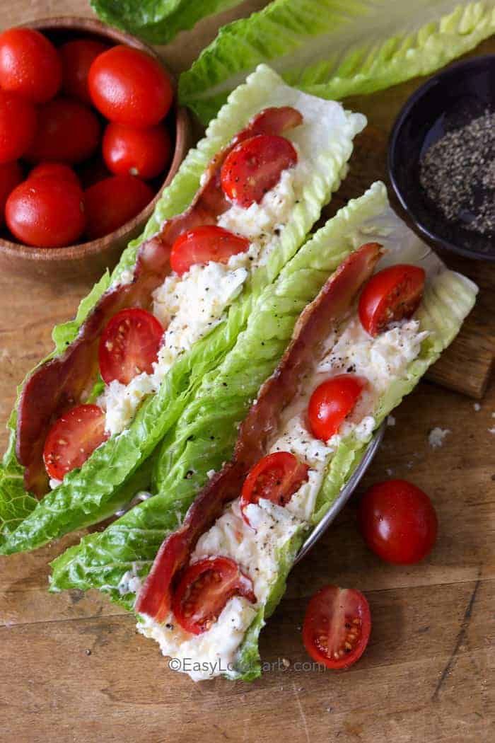 Two BLT Egg Salad Wraps on a wooden board