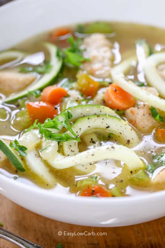 side view of a bowl of low carb chicken soup with zoodles