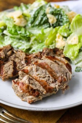 pork tenderloin and salad on a dinner plate