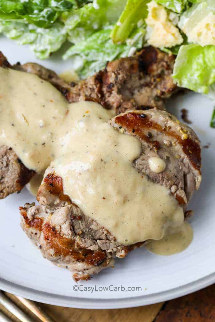 close up of Pork Tenderloin with Creamy Dijon Sauce is a quick and easy low carb recipe. Pork tenderloin is pounded into medallions, grilled to tender perfection then topped with a creamy dijon sauce