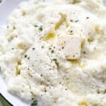 Mashed Cauliflower with butter in a white bowl