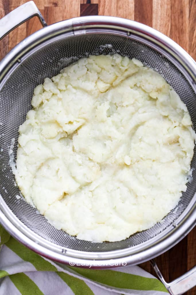 mashed cauliflower in a strainer