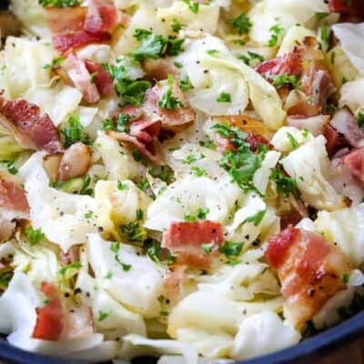 Fried Cabbage With Bacon in a black bowl.