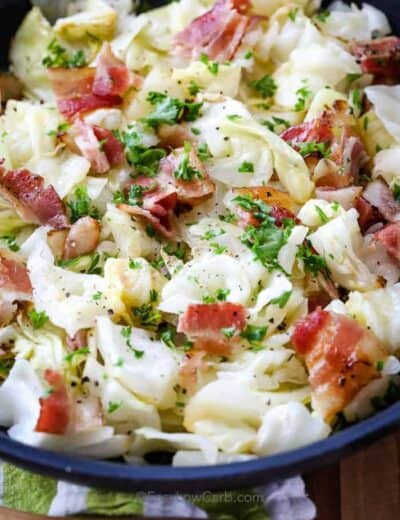 Fried Cabbage With Bacon in a black bowl.