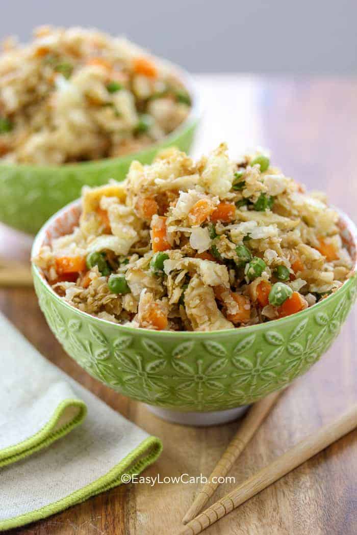 side view of two green bowls filled with Low Carb Cauliflower Fried Rice