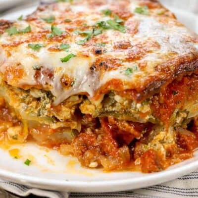 Easy Low Carb Zucchini Lasagna on a white plate, with a fork