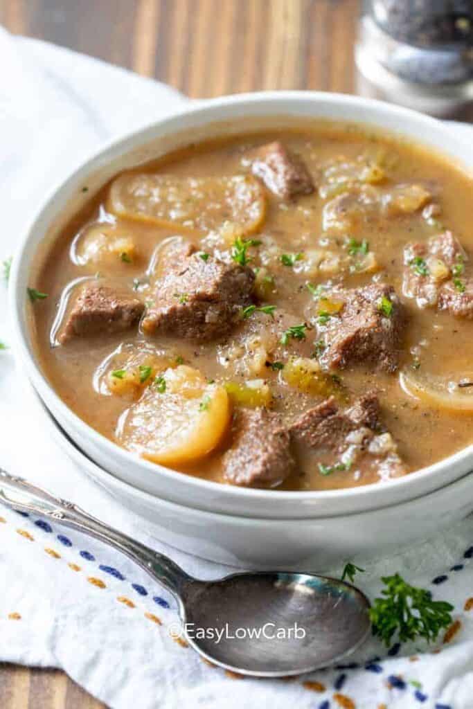 Beef Soup with Radishes in a bowl, with a spoon on the side