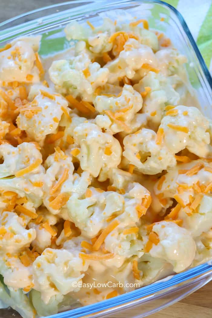 Low Carb Cheesy Cauliflower Casserole prepped with sprinkled cheese, ready for the oven