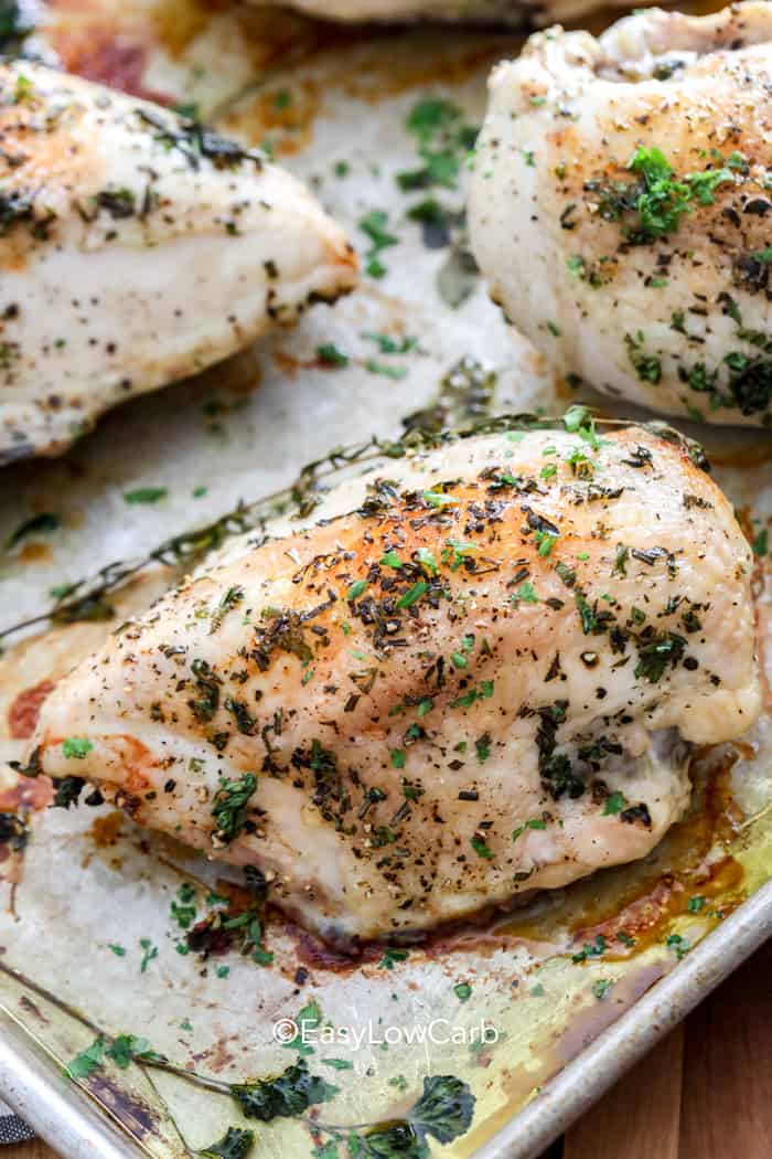 Baked Bone in Chicken Breast with herbs on a baking tray