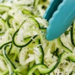 using tongs to pick up zoodles