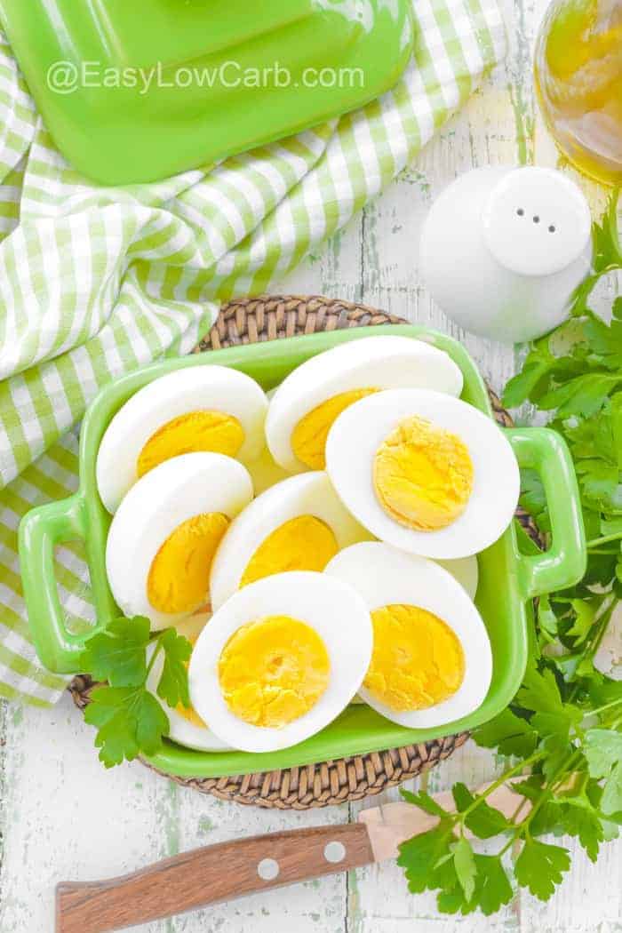 hard boiled egg halves in a green serving dish
