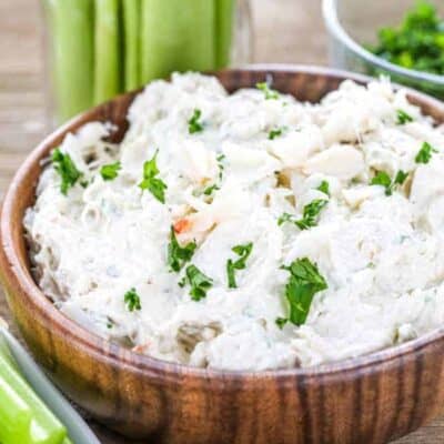 Low carb crab dip in a wood bowl with celery around