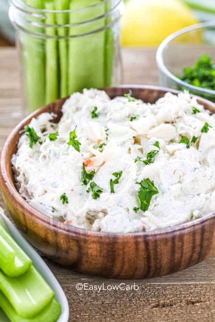 Low carb crab dip in a wood bowl with celery around