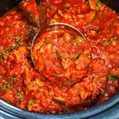 ladle of slow cooker healthy spaghetti sauce