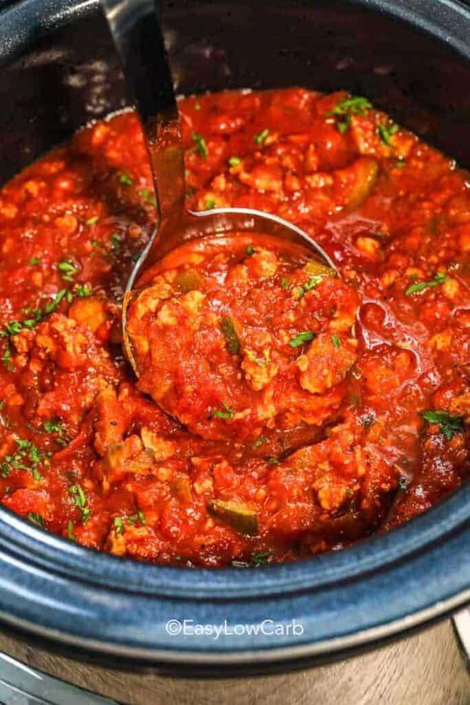 ladle of slow cooker healthy spaghetti sauce