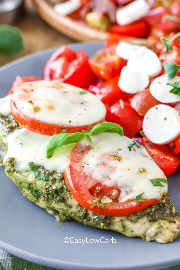Pesto Chicken with tomatoes and cheese on a plate