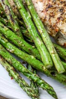 closeup of roasted asparagus on a white plate