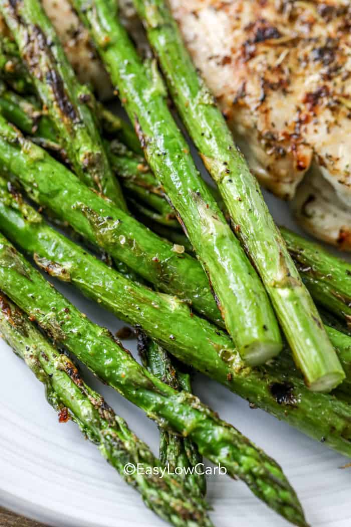 closeup of roasted asparagus on a white plate