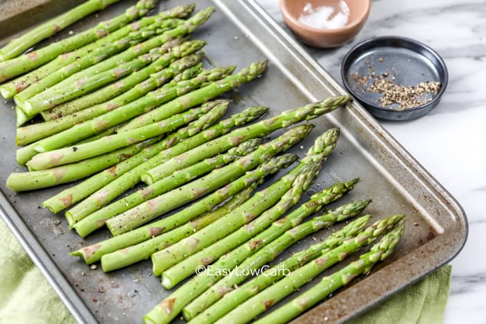 prepped asparagus on a pan for roasting