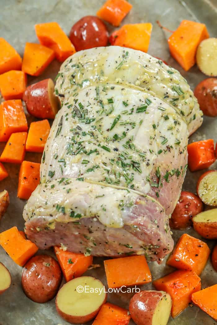 Roasted Pork Loin veggies around on a baking tray before baking