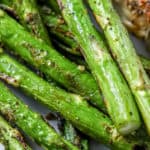 closeup of roasted asparagus on a white plate
