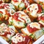 close up of zucchini ravioli baked in a white casserole dish