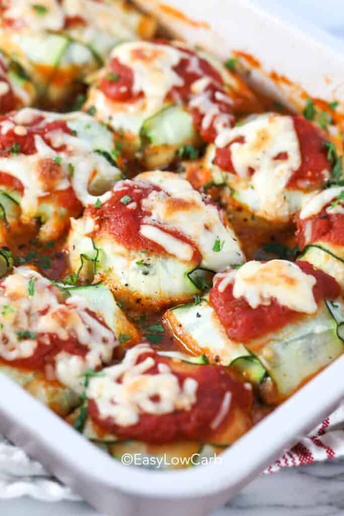 close up of zucchini ravioli baked in a white casserole dish