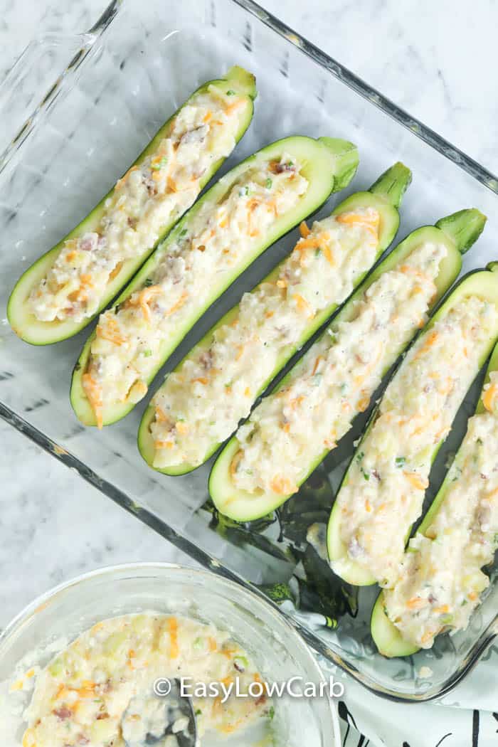 Twice Baked Zucchini prep with zucchini in a glass casserole dish