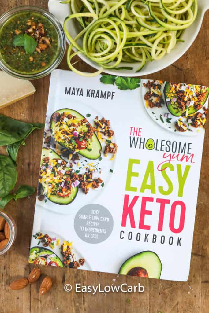 The Wholesome Yum Easy Keto Cookbook with zucchini noodles and almond pesto on the side