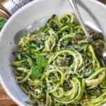 Almond Pesto Zoodles garnished with basil in a white dish