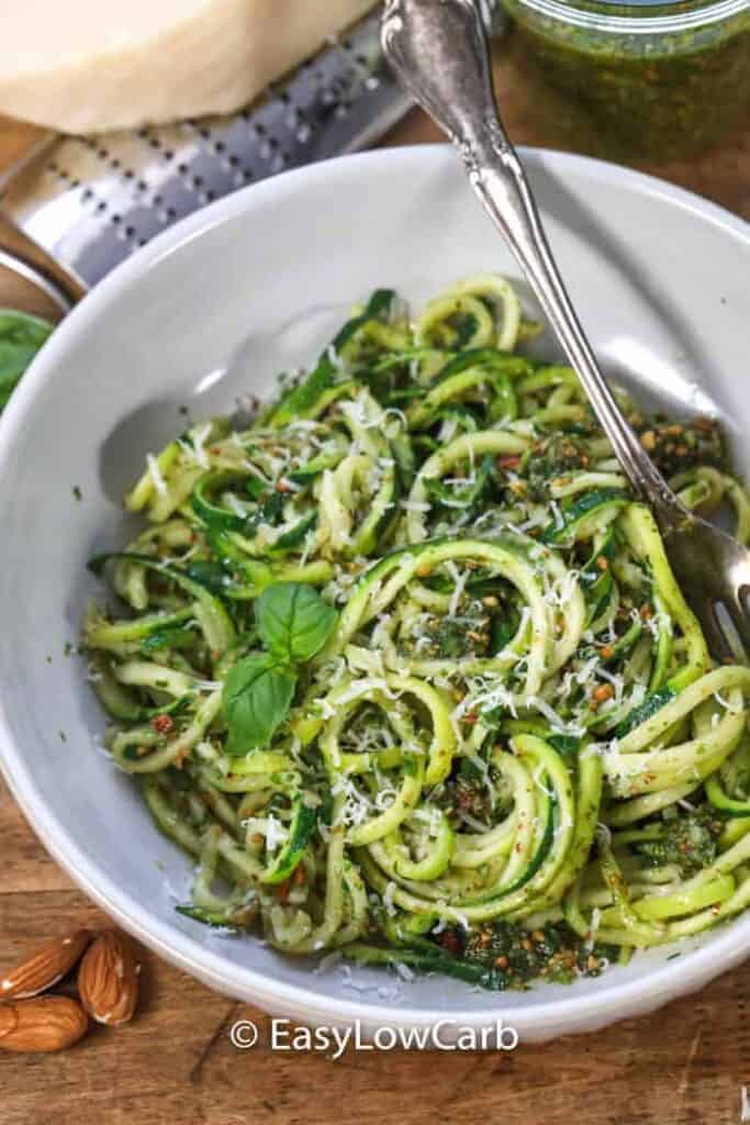 Almond Pesto Zoodles garnished with basil in a white dish