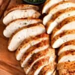 sliced Air Fryer Chicken Breasts on a wooden board