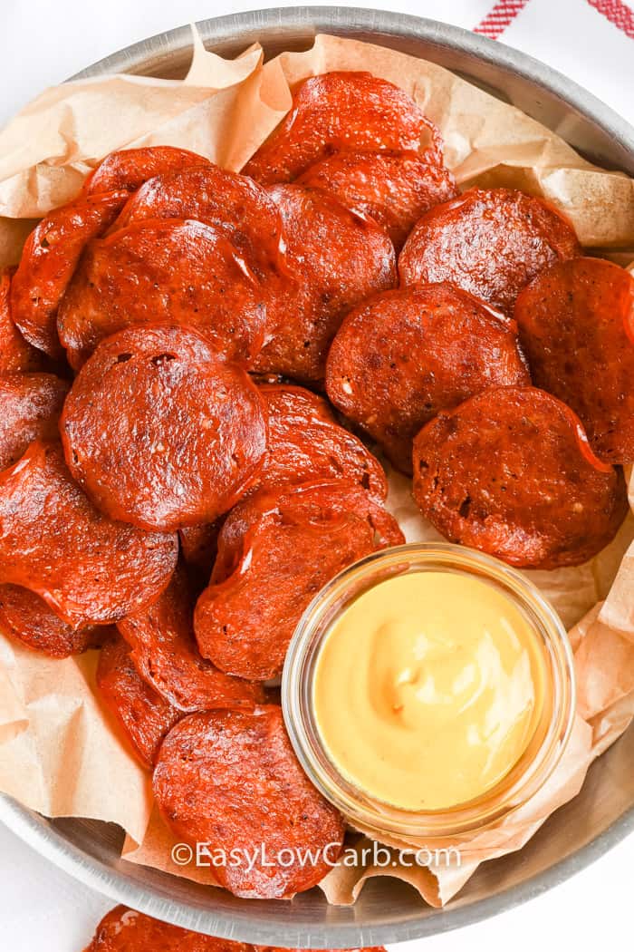 overhead of Crispy Pepperoni Chips on a serving plate with dip