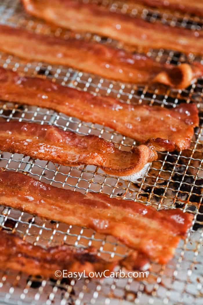 Cooked bacon slices laid out on a rack