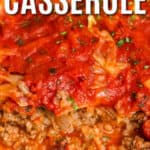 Unstuffed cabbage casserole in white casserole dish with one serving removed, with writing.