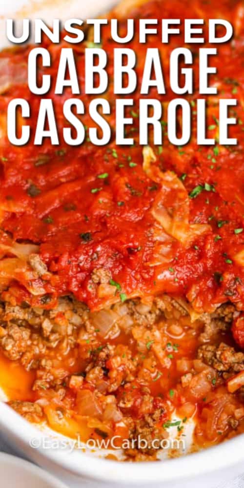 Unstuffed cabbage casserole in white casserole dish with one serving removed, with writing.