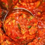 Ladling Slow Cooker Chicken Spaghetti Sauce, with writing.