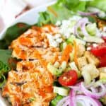 Close up of buffalo chicken salad in a large white bowl