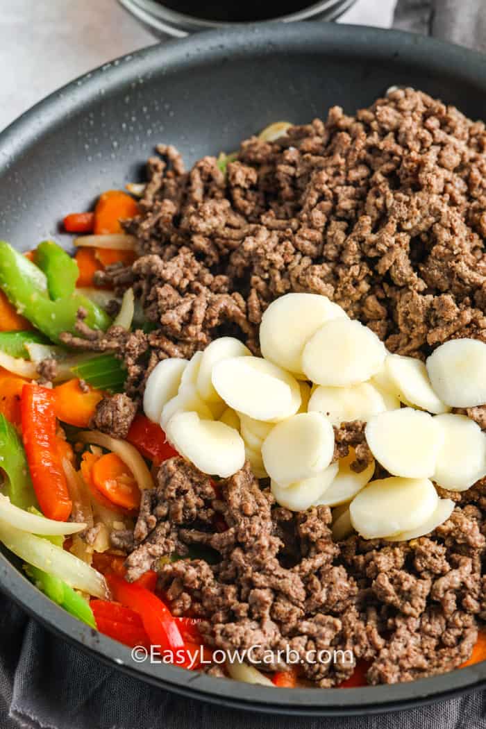 Asian beef stir fry ingredients assembled in a frying pan.
