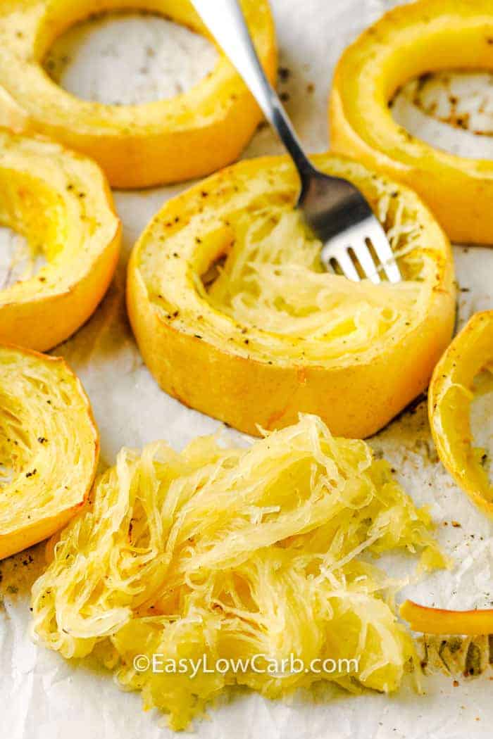 scooping out squash to show How to Cook Spaghetti Squash