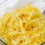 spaghetti squash in glass bowl to show How to Cook Spaghetti Squash
