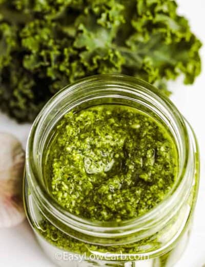 top view of Kale Pesto in a jar and kale beside it