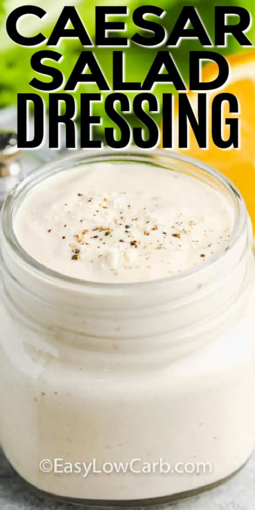 Easy Caesar Salad Dressing in a jar with lettuce and lemon behind it, with a title.