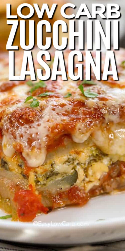 zucchini lasagna on a white plate with writing.
