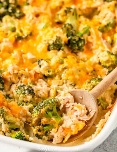 A wooden spoon dishing out low carb chicken broccoli casserole