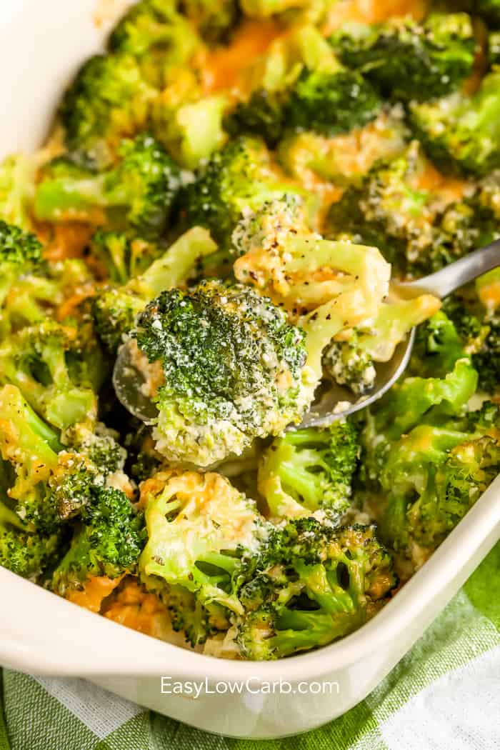 The best broccoli casserole being scooped up with a silver spoon