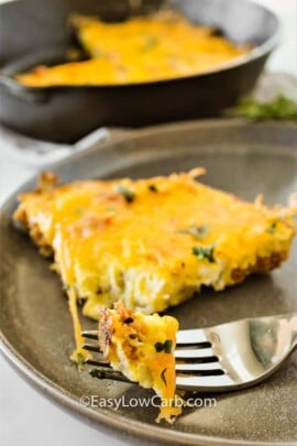 Cheesy Chorizo Frittata on a a plate with a fork with some frittata on it